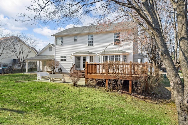 rear view of house featuring a patio area, a deck, and a yard