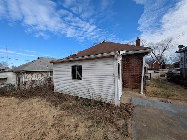 view of side of property with a chimney