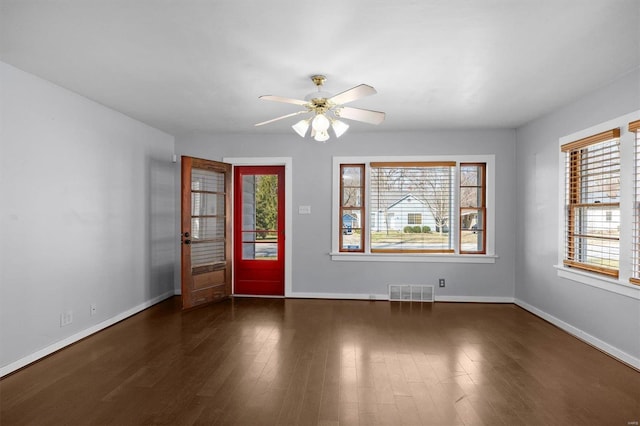 entrance foyer featuring visible vents, baseboards, a ceiling fan, and dark wood-style flooring