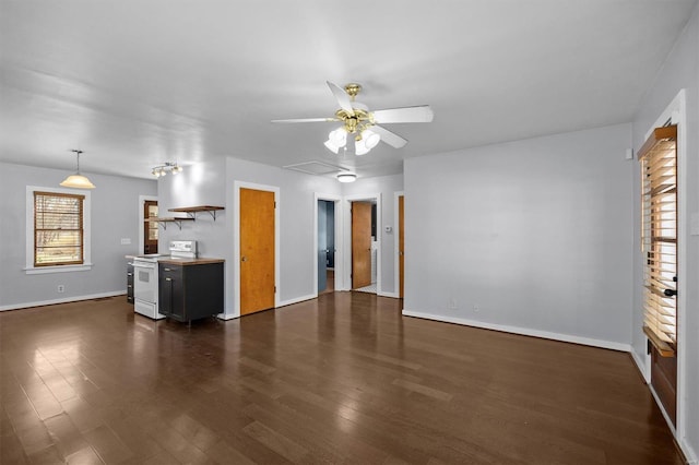 unfurnished living room featuring dark wood-style floors, baseboards, and ceiling fan