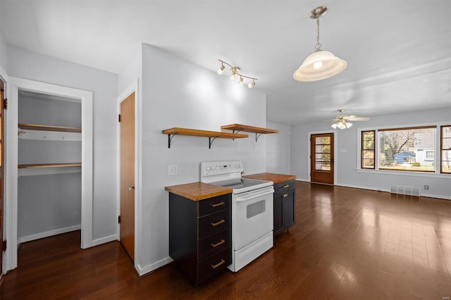 kitchen featuring dark cabinetry, a ceiling fan, visible vents, white electric stove, and butcher block countertops