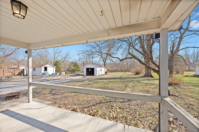 view of patio / terrace featuring a storage shed and an outbuilding