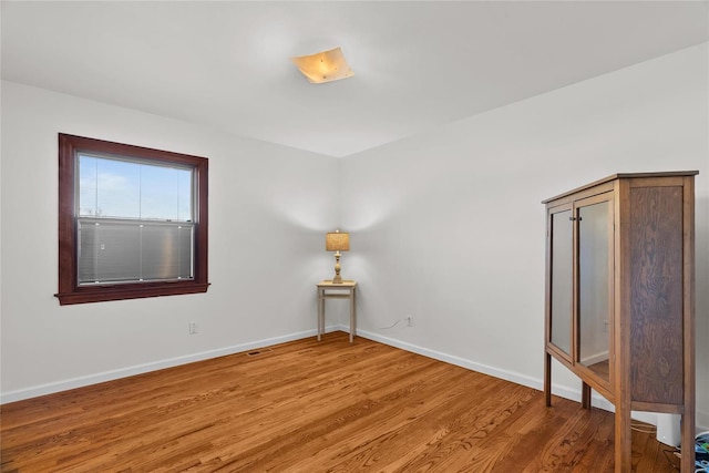 unfurnished room with visible vents, baseboards, and light wood-style floors