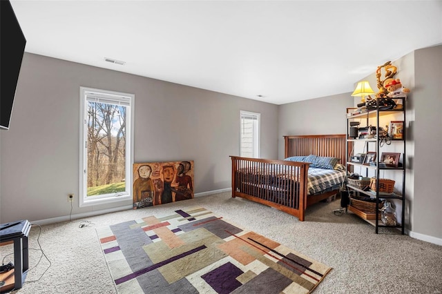 bedroom featuring visible vents, multiple windows, baseboards, and carpet floors