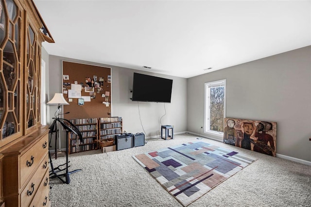 living room featuring visible vents, baseboards, and carpet flooring