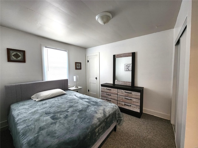 carpeted bedroom featuring baseboards