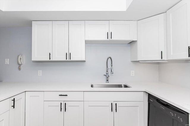 kitchen featuring a sink, dishwasher, white cabinets, and light countertops