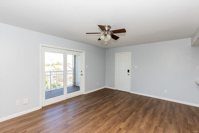 unfurnished room featuring dark wood finished floors, a ceiling fan, and baseboards