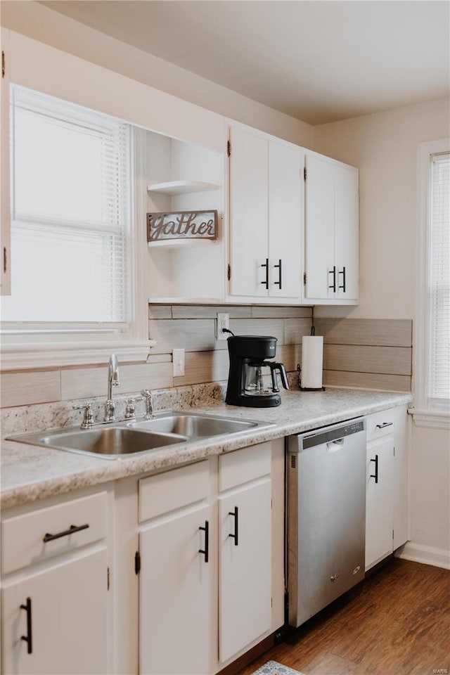 kitchen with a wealth of natural light, a sink, and stainless steel dishwasher