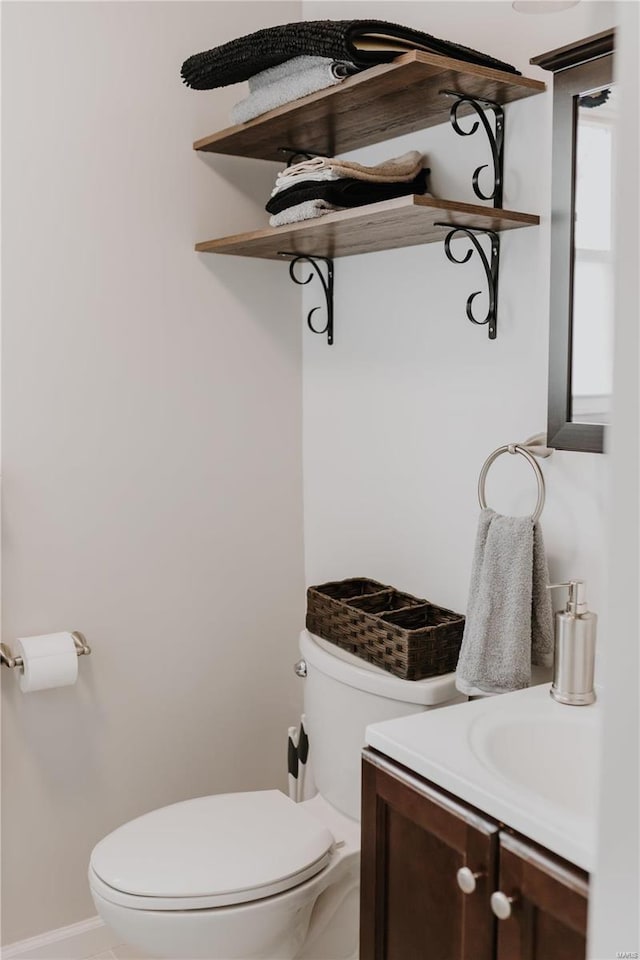 bathroom featuring toilet and vanity