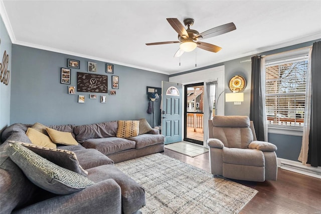 living area with ornamental molding, a ceiling fan, and wood finished floors