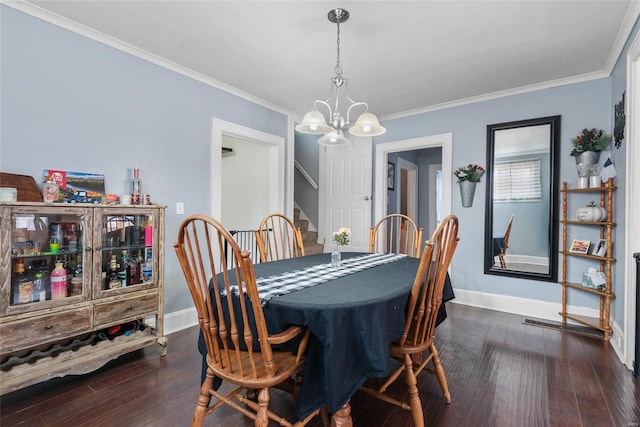 dining room with stairway, ornamental molding, dark wood-style floors, and a chandelier