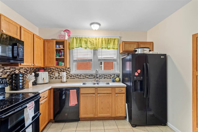 kitchen with a sink, decorative backsplash, black appliances, and light countertops