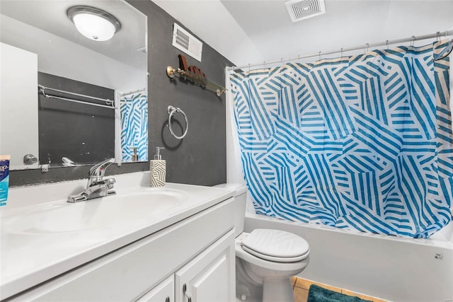 bathroom featuring vanity, visible vents, tile patterned flooring, shower / tub combo, and toilet