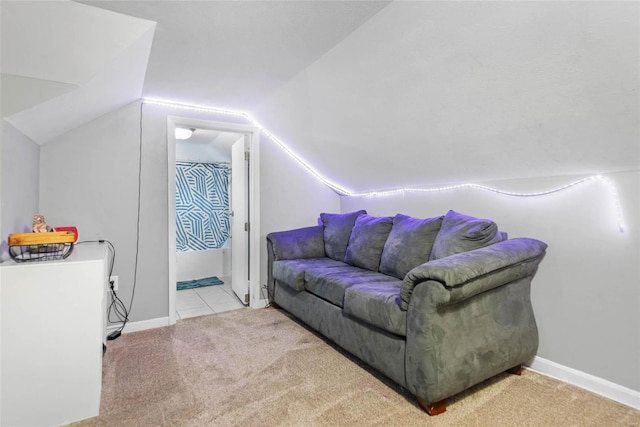 carpeted living room with lofted ceiling and baseboards