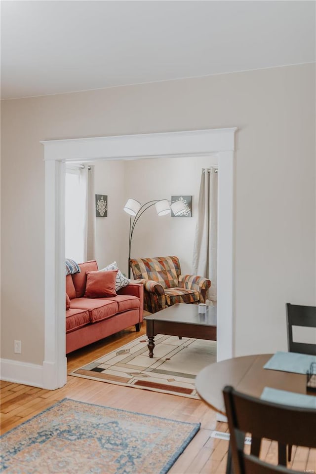 living room featuring wood finished floors and baseboards