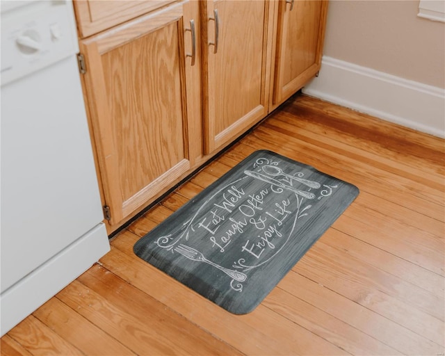 details with white dishwasher and wood finished floors