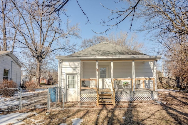 back of house with a porch, a gate, fence, and roof with shingles