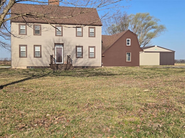 back of house featuring a yard, a chimney, and a shingled roof