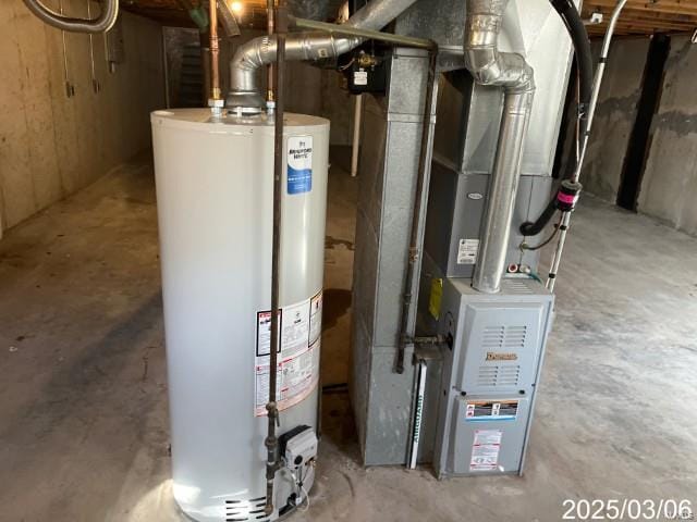 utility room with heating unit and water heater