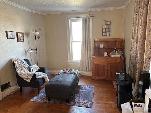 sitting room with wood finished floors, baseboards, and ornamental molding