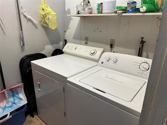 laundry room with light tile patterned floors, washing machine and dryer, and laundry area