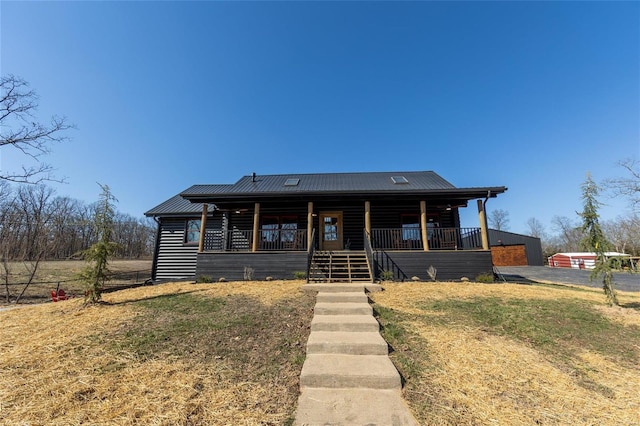 log home with a porch and metal roof