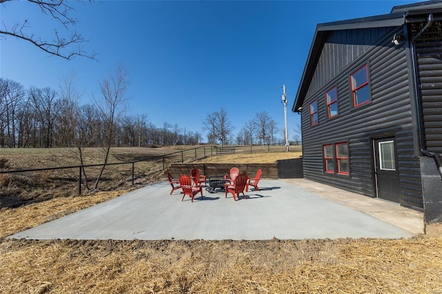 view of patio featuring a fire pit and fence