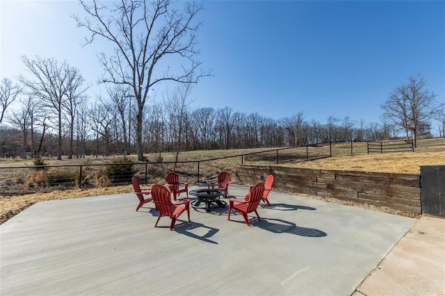 view of patio / terrace with an outdoor fire pit and fence