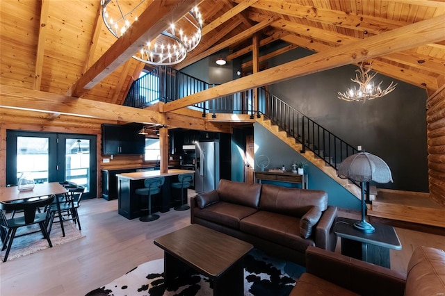 living room with an inviting chandelier, light wood-style flooring, stairs, wood ceiling, and beamed ceiling