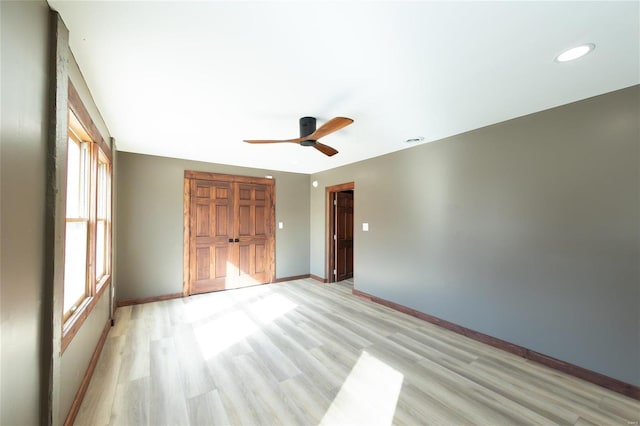 unfurnished bedroom featuring recessed lighting, a ceiling fan, baseboards, and light wood finished floors