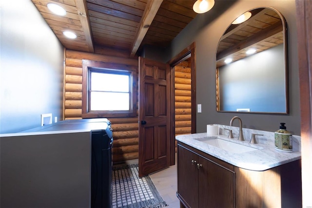 bathroom featuring beamed ceiling, wooden ceiling, and vanity