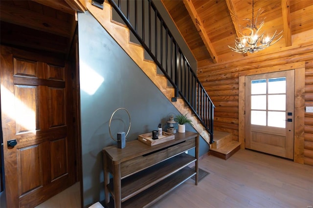 foyer entrance featuring stairway, a notable chandelier, wood ceiling, and light wood finished floors