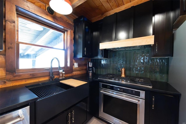 kitchen featuring dark countertops, appliances with stainless steel finishes, and dark cabinetry