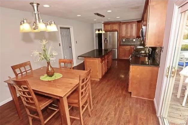 dining space with recessed lighting and dark wood-style flooring