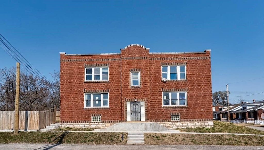 view of building exterior with fence