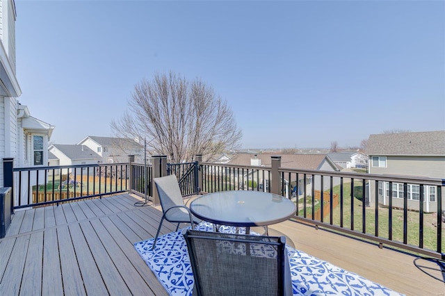 wooden deck with outdoor dining space and a residential view