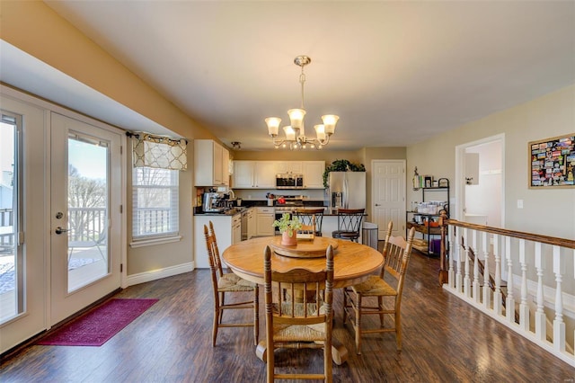 dining area featuring baseboards, a notable chandelier, and dark wood finished floors