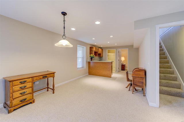 interior space featuring light carpet, pendant lighting, recessed lighting, a peninsula, and baseboards