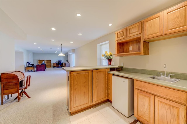 kitchen with a peninsula, recessed lighting, a sink, light countertops, and dishwasher