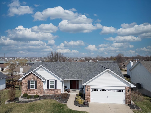 ranch-style home featuring concrete driveway, an attached garage, brick siding, and a shingled roof