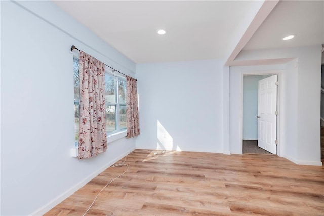 unfurnished room with recessed lighting, wood finished floors, and baseboards