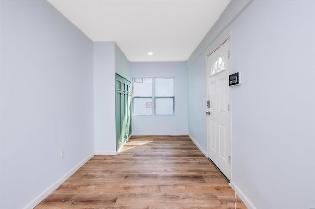 hall featuring baseboards and light wood-style floors