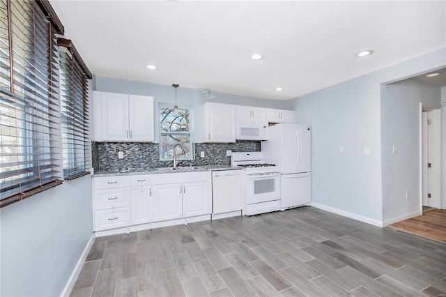 kitchen with light wood-style flooring, a sink, backsplash, white appliances, and white cabinets