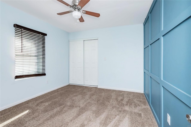 unfurnished bedroom with carpet, baseboards, and ceiling fan