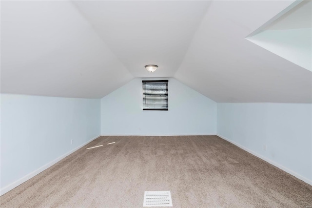 bonus room featuring baseboards, lofted ceiling, and carpet flooring