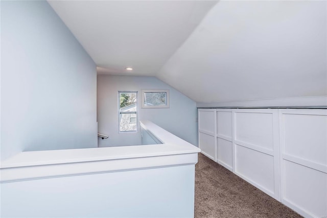 interior space featuring lofted ceiling and carpet