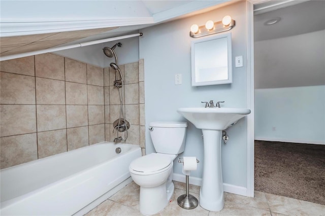 bathroom featuring toilet, lofted ceiling, tile patterned flooring, tub / shower combination, and baseboards