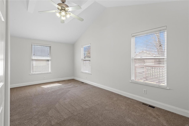 carpeted empty room featuring a wealth of natural light, visible vents, baseboards, and vaulted ceiling