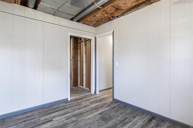 empty room with baseboards and wood finished floors